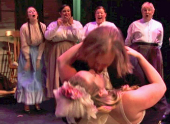 Anthony kisses Angelique while some Chorus members look on.